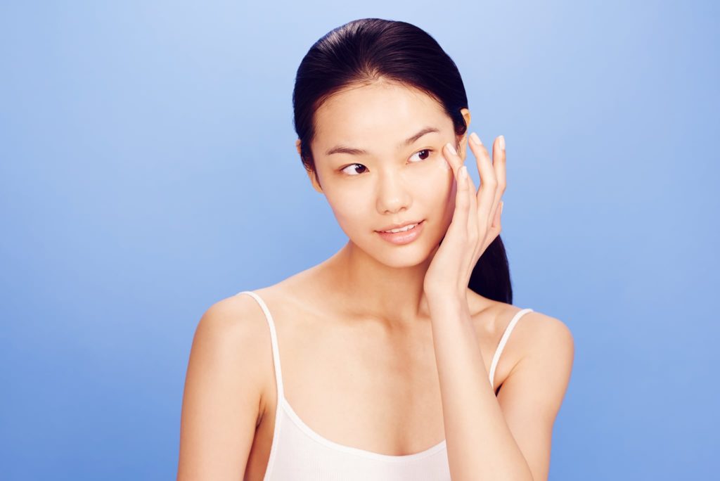 Beautiful Face of Young Woman with Clean Fresh Skin